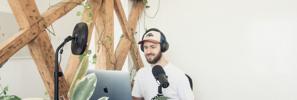man in white crew neck t-shirt wearing black headphones